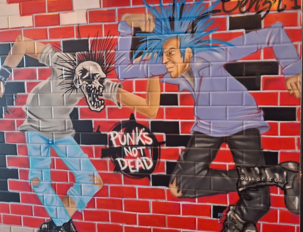 The walls at Legit Dogs & Ice in South Elgin are being painted with punk rock-themed and graffiti-style art. (Mike Danahey/The Courier-News)