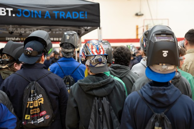 Students wearing welding masks participate in a Western Welding Academy's Blue Collar Tour stope Wednesday at Elgin High School. The tour is designed to introduce students to the jobs available for professional welders. (School District U-46)