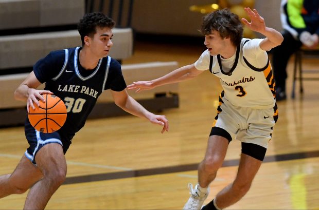 Carmel's Ethan Matz (3) coversLake Park's Luca Stella (30). Carmel's boys basketball team defeated visiting team, Lake Park Lancers 38-30, Saturday Feb. 1, 2025. (Rob Dicker / for the News Sun)