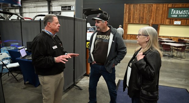 From left, Warren Moulis, co-owner of Munson Marine, Fox Lake Harbor, Chain O'Lakes Marina, all of Fox Lake, and Inland Harbor Marina of Antioch, discusses with Mike and Linda Shake of Johnsburg at the Northern Illinois Boat Show on opening day, Feb. 27, 2025 at the Lake County Fairgrounds (1060 E. Peterson Road) in Grayslake. (Karie Angell Luc/Lake County News-Sun)