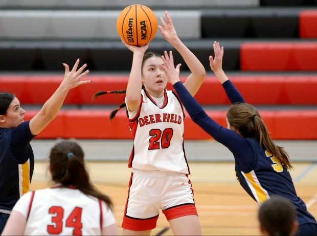 Deerfield's Eve Engler (20), getting her shot between Glenbrook South's Jackie Addesso (30) and Faith Oswald (right), during the game on Friday, Jan. 31, 2025, in Deerfield. (Mark Ukena/for the Lake County News-Sun)