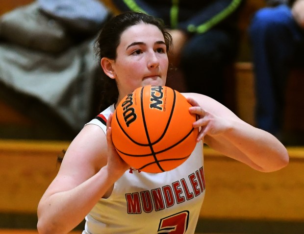 Mundelein's Adrianna Lesniak (3) drains a first quarter three-pointer. The Mundelein's girls basketball team hosted neighboring Libertyville and lost to the Wildcats 51-44, Friday, Jan. 31, 2025. (Rob Dicker / for the News Sun)