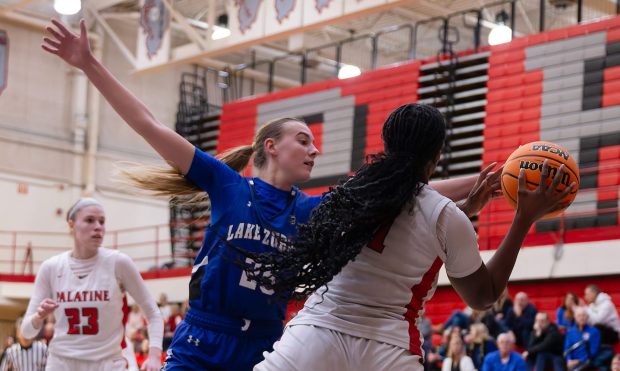 Leah Gilbertson (25) from Lake Zurich defends Halle Onyekonwu (11) from Palatine during the third quarter of their girls basketball game at Palatine High School on Saturday, Feb. 8, 2025 in Palatine, Illinois. The Bears beat the Pirates 53-51. ( John Konstantaras-News-Sun )..00095274A LNS-L-GBK-LZ-PAL-0209