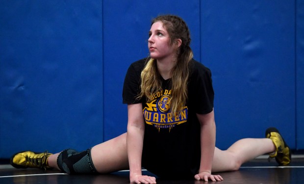 Erin Bush stretches after finishing her laps around the wrestling room. Members of the Warren Girls Westling team work out in preparation for the upcoming Sectionals, Thursday, Feb. 6, 2025. (Rob Dicker / for the News Sun)