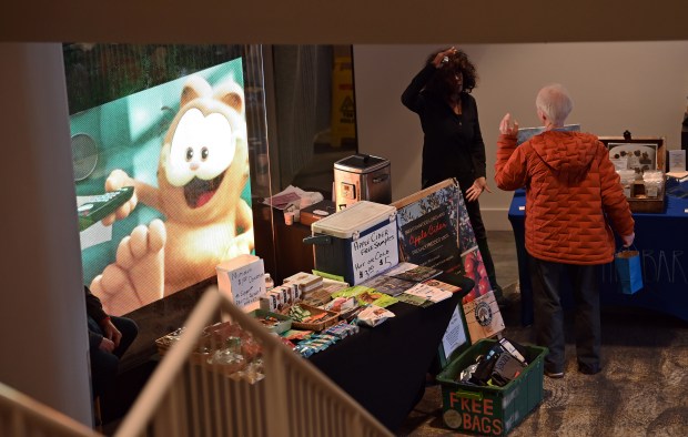 Top, center, downstairs staffing a table is nutritious snack vendor and artist Piper Baracani of Highland Park, of Piper's Otherbar.net at the Indoor Winter Ravinia Farmers Market on Feb. 15, 2025 in Highland Park at the Wayfarer Theaters. (Karie Angell Luc/Lake County News-Sun)