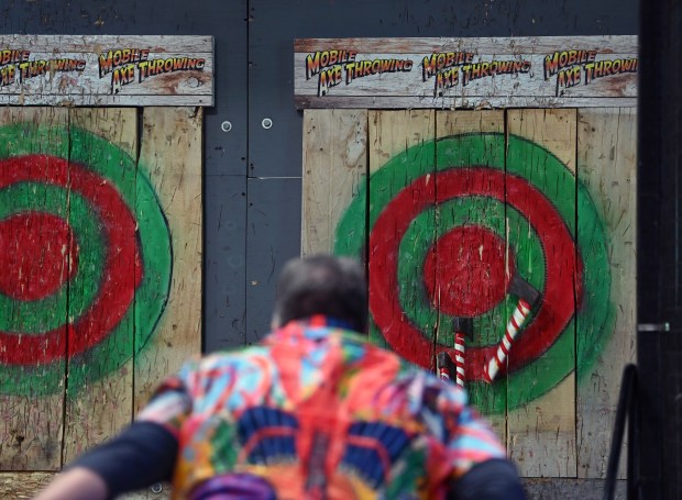 Taking the axe throwing challenge with the third axe almost sticking is Andrew Szymanski of Lombard at the Lake County Craft Beer Festival in Expo Hall at the Lake County Fairgrounds in Grayslake on Feb. 22, 2025. (Karie Angell Luc/Lake County News-Sun)