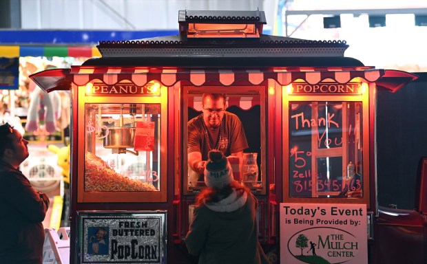 Serving popcorn for a charitable cause is vendor Scott Uglinica of Volo at the Lake County Craft Beer Festival in Expo Hall at the Lake County Fairgrounds in Grayslake on Feb. 22, 2025. (Karie Angell Luc/Lake County News-Sun)