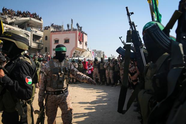 Hamas and Islamic Jihad fighters secure the area as Red Cross representatives wait for the handover of Thai and Israeli hostages in Khan Younis, southern Gaza Strip, Thursday Jan. 30, 2025.(AP Photo/Jehad Alshrafi)