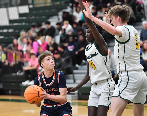 Naperville North's Miles Okyne looks to shoot while double teamed by Waubonsie Valley's Moses Wilson (4) and Cade Valek during a game on Tuesday, Jan. 7, 2025 in Aurora...(Jon Cunningham/for The Naperville Sun)