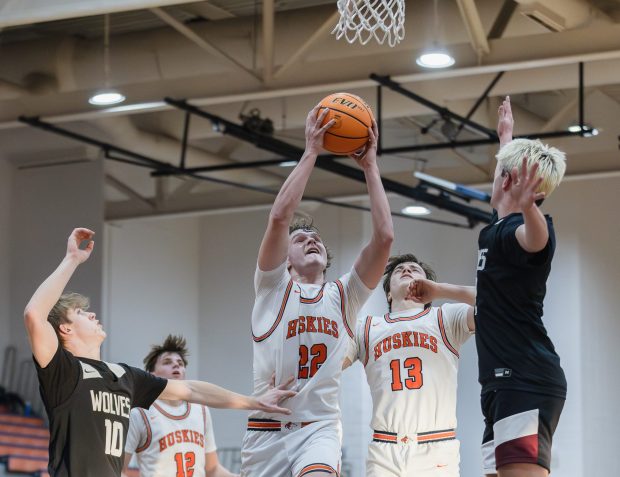 Naperville North's Will Harvey (22) grabs a rebound against Prairie Ridge during a non-conference game in Naperville on Friday, Jan. 3, 2025. (Troy Stolt / for the Naperville Sun)