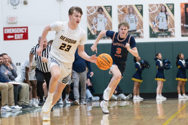 Neuqua Valley's Cole Kelly pushes the ball up the court on a fast break