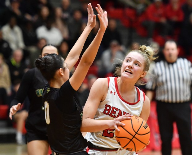 Waubonsie Valley's Maya Pereda draws a charge from Benet's Bridget Rifenburg