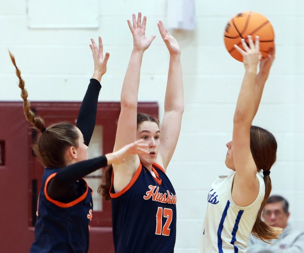 Naperville North's Anna Richards , center, defends during the Montini Christmas Girls Basketball Tournament against Burlington's Central High School in Lombard on Thursday, Dec. 26, 2024. (James C. Svehla / Naperville Sun)