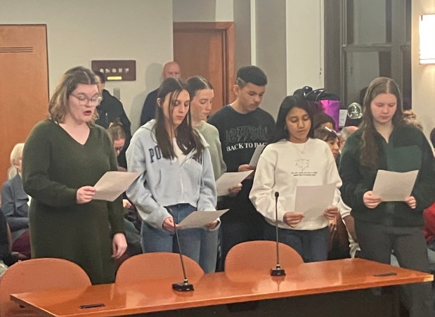 Student delegates to the Oak Park and River Forest High School board, from left, Iris Keane, Isabel Haneberg-Ruiz, Miriam Beutler, Leonidas Campbell, Gayatri Gadhvi and Olive Tepfer, are sworn in during a Feb. 20 School Board meeting. (Bob Skolnik/Pioneer Press)