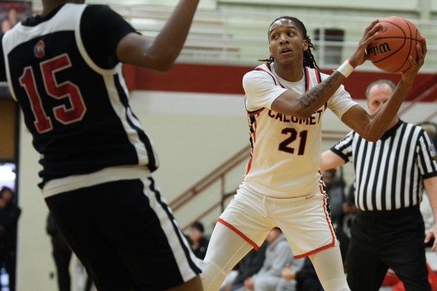 Calumet guard Johnnie Hudson looks for a path to pass the ball past 21st Century guard Chris Wilcher during their game on Monday, Jan. 13, 2025. (Kyle Telechan/for the Post-Tribune)