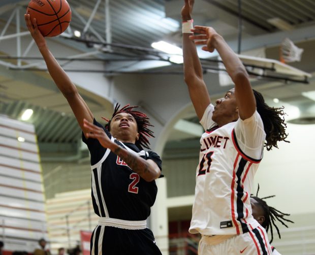 21st Century guard Ronald Mosley takes the ball up against Calumet guard Johnnie Hudson during their game on Monday, Jan. 13, 2025. (Kyle Telechan/for the Post-Tribune)