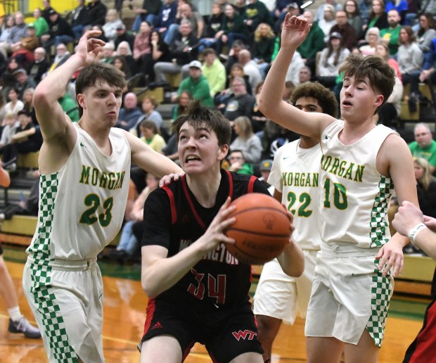 Washington Township's Rob McGowan goes to the basket between Morgan Township's Mason Willingham and Cal Lemmons