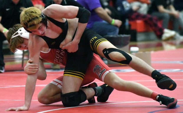 Griffith's Zach Kenney wrestles against Crown Point's Teigan Newell