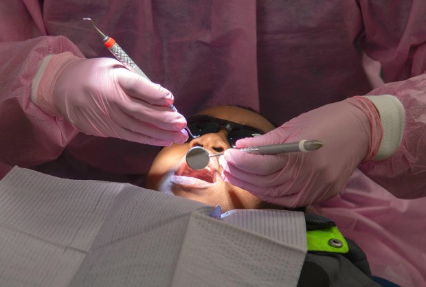 Eleven-year-old Adriene Flowers has his teeth cleaned during the annual "Give Kids a Smile" event at Indiana University Northwest in Gary on Saturday, Feb. 15, 2025. (Michael Gard/for the Post-Tribune)