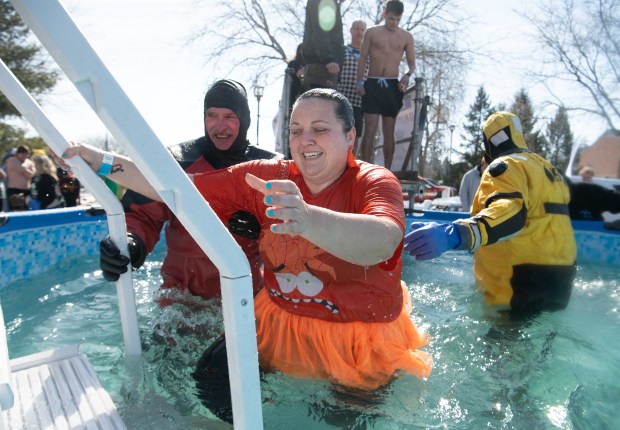 Melissa Diekelmann exits the small pool after jumping in during the Polar Plunge for Special Olympics Indiana outside the Athletics-Recreation Center at Valparaiso University Saturday, Feb. 22, 2025. Diekelmann, of Griffith, is a special education teacher and part of a group from Griffith High School. (Andy Lavalley/for the Post-Tribune)