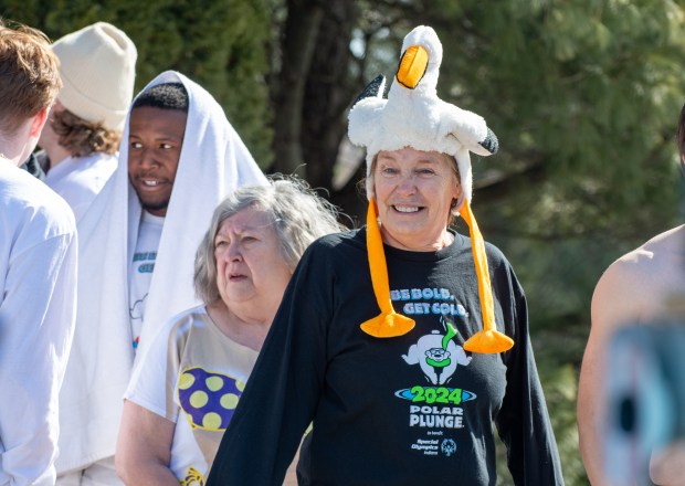 Jonnie Pera, of Valparaiso, manages a smile while waiting in line to jump during the Polar Plunge for Special Olympics Indiana outside the Athletics-Recreation Center at Valparaiso University Saturday, Feb. 22, 2025. (Andy Lavalley/for the Post-Tribune)