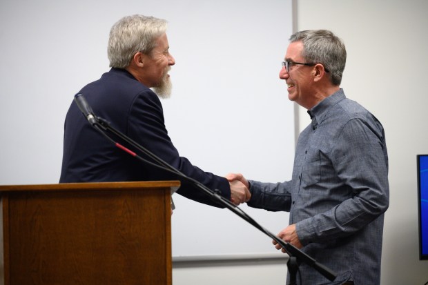 Valparaiso University professor Martin Buinicki, on left, shakes hands with president and publisher at Goodman Games Joseph Goodman during the grand opening of the school's Center for Games and Interactive Entertainment on Tuesday, Feb. 4, 2025. (Kyle Telechan/for the Post-Tribune)