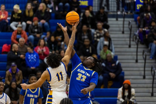 Crete-Monee's Robert Kennedy Jr (11) and Bloom Township's Joe Jones (33) on the tipoff in overtime during a Southland Athletic game in Crete on Friday, Jan. 31, 2025. (Vincent D. Johnson / for the Daily Southtown)