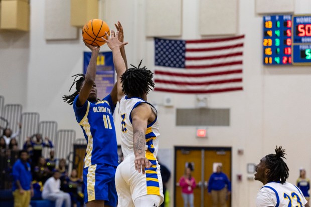 Crete-Monee's Robert Kennedy Jr gets in Bloom Township's Adam Page's face on a shot during the final seconds of overtime in a Southland Athletic game in Crete on Friday, Jan. 31, 2025. (Vincent D. Johnson / for the Daily Southtown)