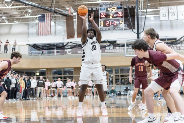 Mount Carmel's Claude Mpouma (50) shoots a free throw against Brother Rice during a CCL game in Chicago on Friday, Feb. 14, 2025. (Troy Stolt / for the Daily Southtown)