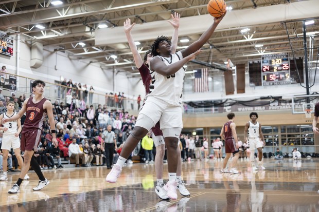 Mount Carmel's Claude Mpouma (50) goes up for a layup against Brother Rice during a CCL game in Chicago on Friday, Feb. 14, 2025. (Troy Stolt / for the Daily Southtown)