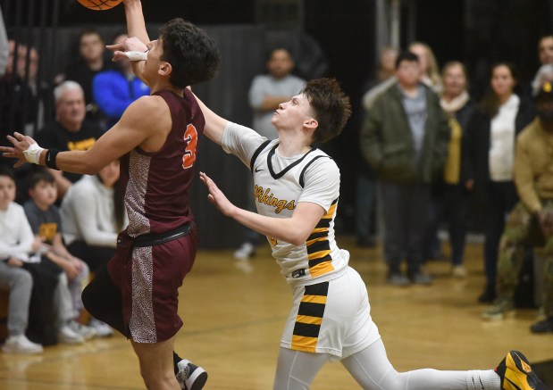 Brother Rice's Marcos Gonzales (3) tries to lay in a basket against St. Laurence's Bradley Stratton (0) during a Chicago Catholic League game Tuesday, Feb. 11, 2025 in Burbank, IL. (Steve Johnston/for the Daily Southtown)