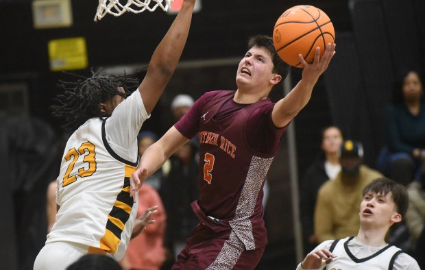 Brother Rice's Jack Weigus (2) drives to the basket against St. Laurence's Markese Peoples (23) during a Chicago Catholic League game Tuesday, Feb. 11, 2025 in Burbank, IL. (Steve Johnston/for the Daily Southtown)