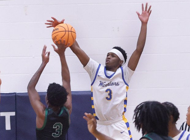 Crete-Monee's Jaydon Watts (3) blocks a shot by Evergreen Park's Arshawn Powell (3) in the second half during a Class 3A Hillcrest Regional semifinal basketball game on Wednesday Feb. 26, 2025.(John Smierciak / Daily Southtown)