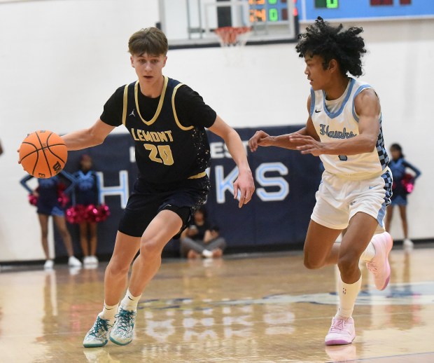 Lemont's Matas Gaidukevicius (20) works to the basket against Hillcrest's Jamir Ratliff (1) during a South Suburban Conference game Friday, Feb. 14, 2025 in Country Club Hills, IL. (Steve Johnston/for the Daily Southtown)