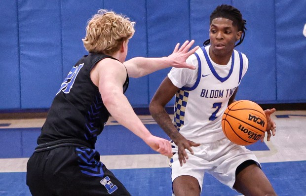 Bloom's Ethan Wilson (2) ties to drive around Lincoln-Way East's Landon Johnson (21( during a basketball game in Chicago Heights on Monday, Feb.10, 2025 (John Smierciak / Daily Southtown)