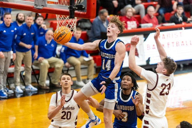 Sandburg's Connor Gleason (14) flies to the basket for two against Lockport during the Class 4A Marist Regional semifinals in Chicago on Wednesday, Feb. 26, 2025. (Vincent D. Johnson / for the Daily Southtown)