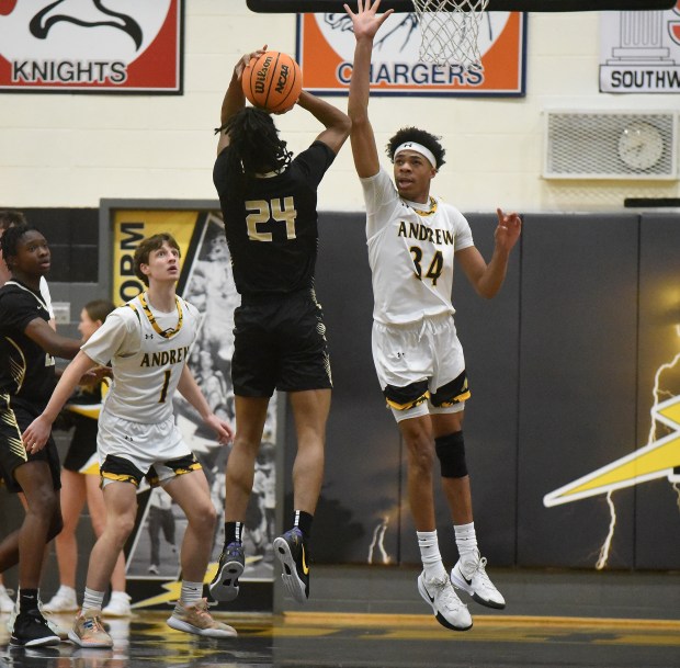 Oak Forest's Matthew Anderson (24) tries to get his shot off over Andrew's Mason Moore (34) during a nonconference game Wednesday, Feb. 5, 2025 in Tinley Park, IL. (Steve Johnston/for the Daily Southtown)