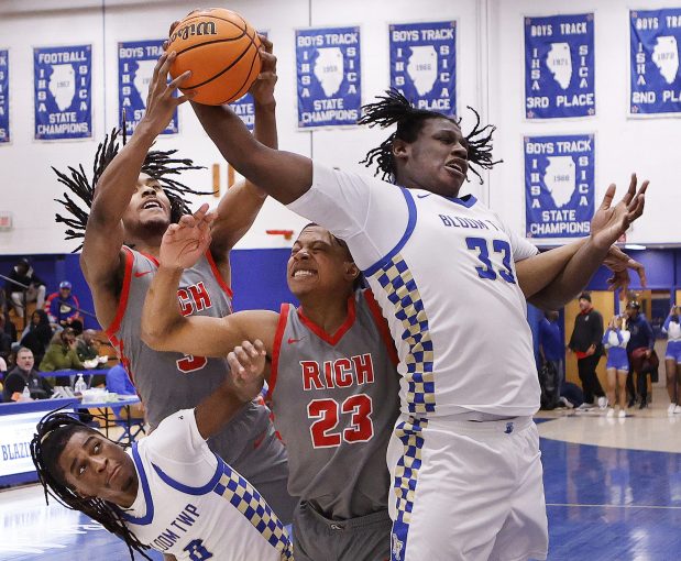 Bloom's Joe Jones (33) rips a rebound out of the hands of Rich Township's Jamson Coulter (3) during a basketball game in Chicago Heights on Tuesday, Feb.4, 2025 (John Smierciak / Daily Southtown)