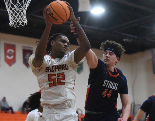 Shepard's Jovan Thomas Jr (52) pulls down the rebound in front of Stagg's Domas Narcevicius (44) during the Class 4A Romeoville Regional quarterfinal Monday, Feb. 24, 2025 in Palos Heights, IL. (Steve Johnston/for the Daily Southtown)