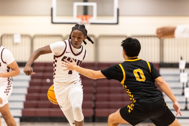 Southland Prep's David Shaw (1) dribbles behind his back as Reed-Custer's Dom Eddy (0) steps up to guard him in the Class 2A Coal City Regional quarterfinal in Richton Park on Monday, Feb. 24, 2025. (Vincent D. Johnson / for the Daily Southtown)