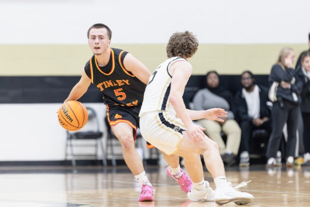 Tinley Park's Nolan Maciejewski (5) brings the ball down court against Oak Forest during an SSC game in Oak Forest on Friday, Jan. 31, 2025. (Troy Stolt / for the Daily Southtown)