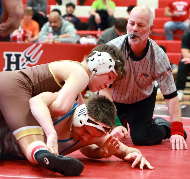 Mt. Carmel's Seth Mendoza, top, and West Aurora's Evan Matkovich, bottom, during the 138 Class 3A Hinsdale Central Wrestling Sectional in Hinsdale on Saturday, Feb. 15, 2025. (James C. Svehla / for the Daily Southtown)