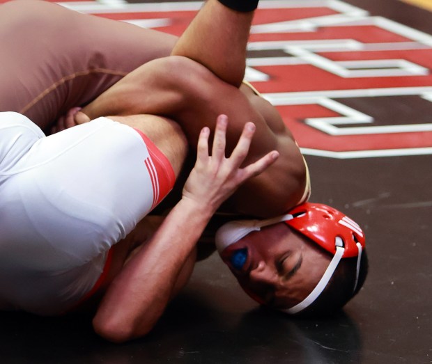 Mt Carmel's Kavel Moore, right, pins Glenbard East's Ismael Chaidez during the 120 Class 3A Hinsdale Central Wrestling Sectional in Hinsdale on Saturday, Feb. 15, 2025. (James C. Svehla / for the Daily Southtown)