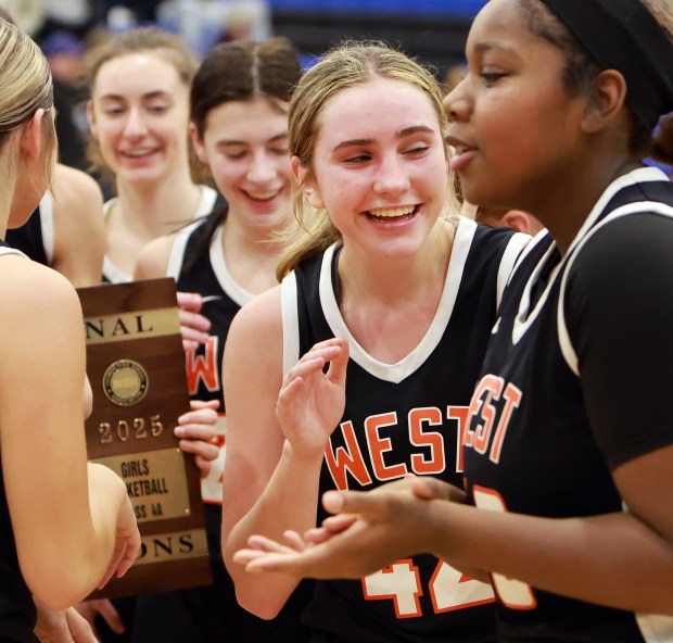 Lincoln-Way West's Reagan McCracken, center, celebrates with teammates their win over Lincoln-Way East during the Class 4A Lincoln-Way East Regional final girls basketball game in Frankfort on Thursday, Feb 20, 2025. (James C. Svehla / for the Daily Southtown)