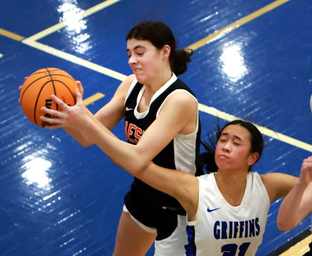 Lincoln-Way West's Mackenzie Roesner, left, and Lincoln-Way East's Mia Limpin, right, reach for a rebound during the Class 4A Lincoln-Way East Regional final girls basketball game in Frankfort on Thursday, Feb 20, 2025. (James C. Svehla / for the Daily Southtown)