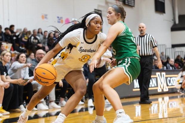 Marian Catholic's Taylor Bolton (3) drives to the basket against Providence during the Class 3A Marian Catholic Sectional final in Chicago Heights on Thursday, Feb. 27, 2025. (Troy Stolt / for the Daily Southtown)