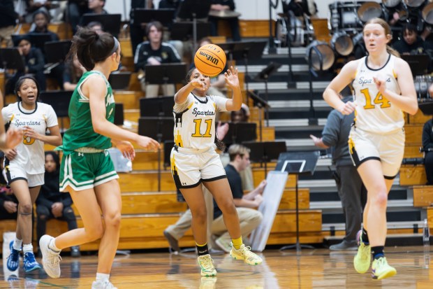 Marian Catholic's Alainna Poisson (11) passes the ball against Providence during the Class 3A Marian Catholic Sectional final in Chicago Heights on Thursday, Feb. 27, 2025. (Troy Stolt / for the Daily Southtown)