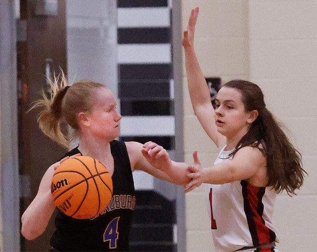 Marist's Olivia Cosme (right) guards Sandburg's Ellie Driscoll (left) during a Class 4A Rich Township Sectional semifinal basketball game in Richton Park on Tuesday, Feb. 25, 2025. (John Smierciak / Daily Southtown)