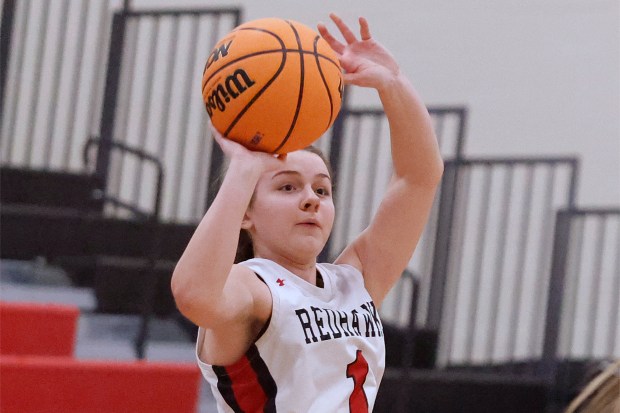 Marist's Olivia Cosme hits for three points against Sandburg during a Class 4A Rich Township Sectional semifinal basketball game in Richton Park on Tuesday, Feb. 25, 2025. (John Smierciak / Daily Southtown)