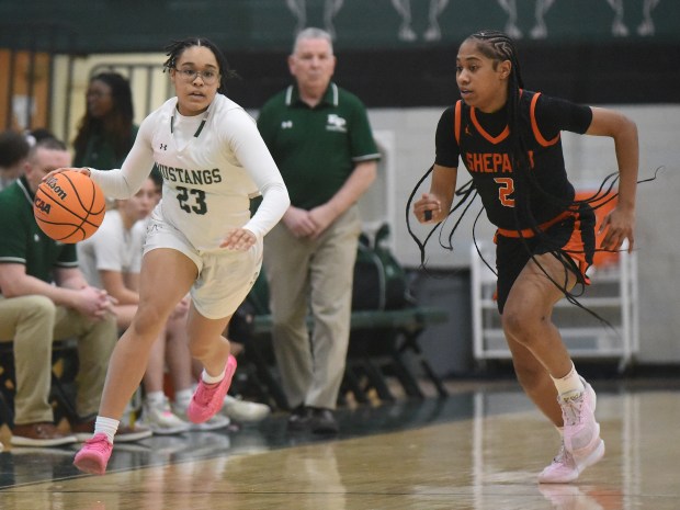 Evergreen Park's Trinty Jones (23) works the ball up court against Shepard's Mia Stokes (2) during a South Suburban Conference game Thursday, Feb. 13, 2025 in Evergreen Park, IL. (Steve Johnston/for the Daily Southtown)